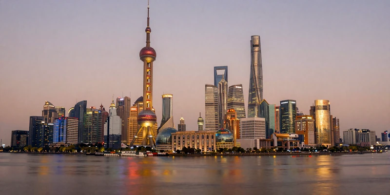 Modern Shanghai Pudong skyline at dusk reflecting on the Huangpu River representing cosmopolitan Chinese dating culture
