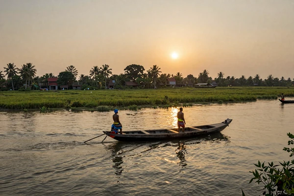 Beautiful Bangladeshi river delta landscape with traditional boats and green rice paddies at sunset