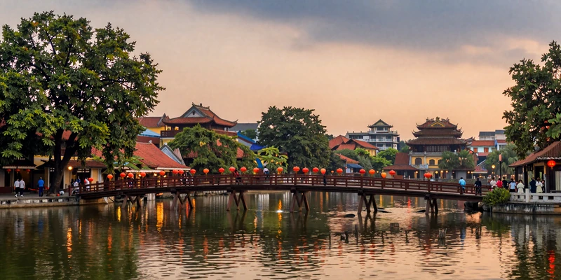 Scenic Hoan Kiem Lake in Hanoi Vietnam at dusk with The Huc Bridge and warm lantern light